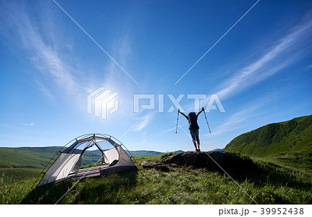 Silhouette of woman climber near camping against blue sky in the morning 39952438