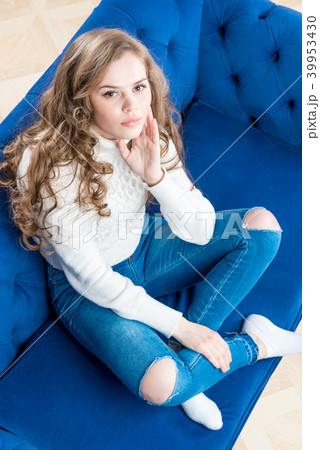 cute girl in a warm sweater on the couch cute girl in a warm sweater on the couch 39953430