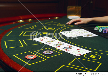 Casino black jack table with chips and cards.  39954620