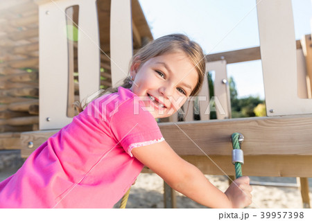Little girl climbing on adventure playground 39957398