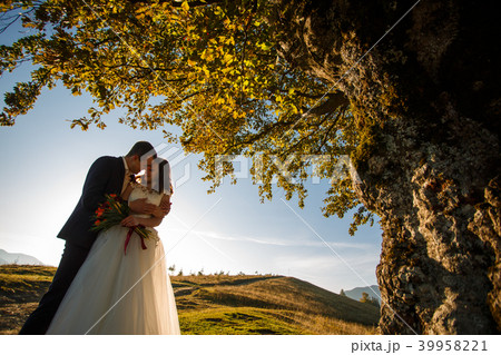 Man and woman Just married in the mountains at sunset. Man and woman Just married in the mountains at sunset. 39958221