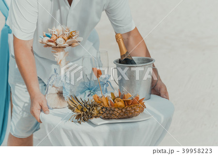 Table decorated with bottle of champagne and fruit Table decorated with bottle of champagne and fruit 39958223
