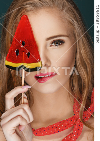 blond woman with lollipop blue background. 39959611