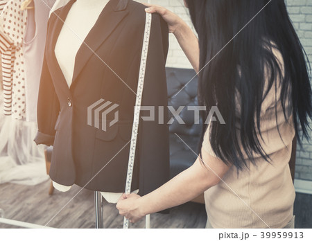 Fashion Designer hand is measuring jacket length 39959913