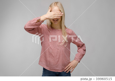 Portrait of attractive sweet adorable blonde teenager girl in glasses in pink blouse closing her Portrait of attractive sweet adorable blonde teenager girl in glasses in pink blouse closing her 39960515