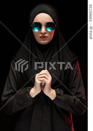 Portrait of beautiful stylish young muslim woman wearing black hijab and sunglasses as modern 39960726