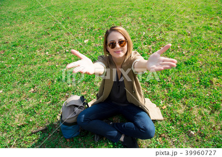 girl sitting on green grass in a park 39960727