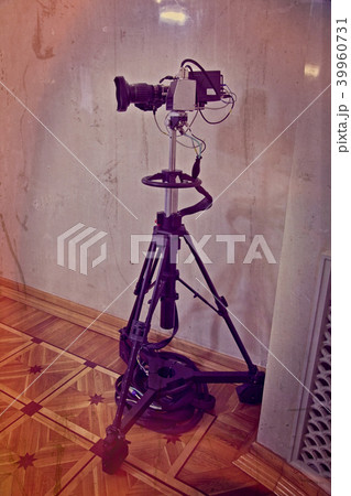 Video camera on a tripod 39960731