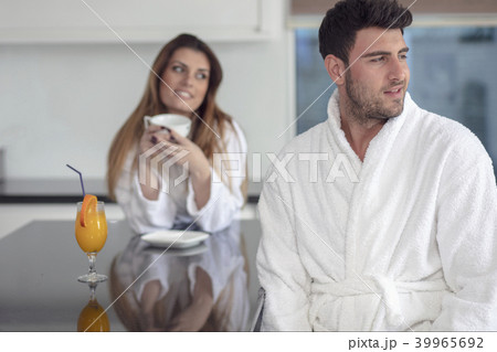 Portrait of a man and his wife in the kitchen while having breakfast Portrait of a man and his wife in the kitchen while having breakfast 39965692
