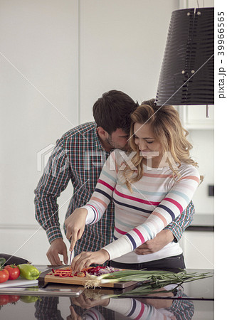Portrait of happy young couple cooking together in the kitchen at home. Portrait of happy young couple cooking together in the kitchen at home. 39966565