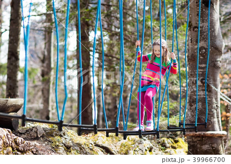 Child in adventure park. Kids climbing rope trail. Child in adventure park. Kids climbing rope trail. 39966700