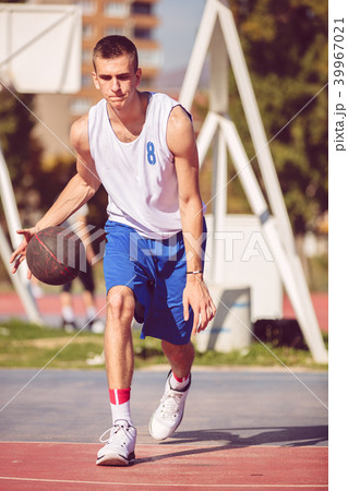 Handsome male playing basketball outdoor Handsome male playing basketball outdoor 39967021