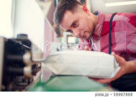 Image of brunet businessman next to apparatus Image of brunet businessman next to apparatus 39967868