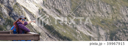 Smiling woman against backdrop of picturesque mountain landscape Smiling woman against backdrop of picturesque mountain landscape 39967915