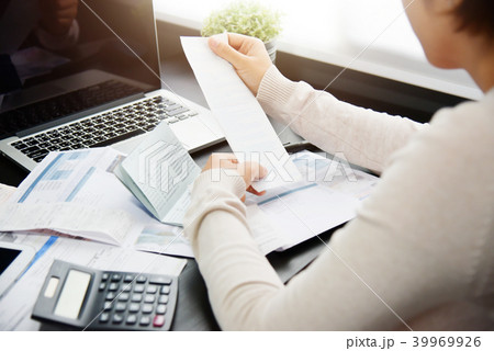 Woman calculating her Debt. 39969926