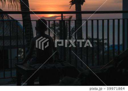 Silhouette of a child on tropical sunset over sea. 39971864