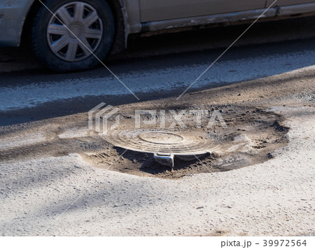Dangerous pit on the road Dangerous pit on the road 39972564