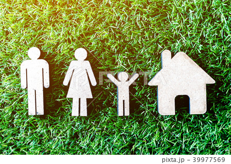 Wooden family and home on green grass 39977569