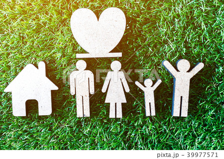 Wooden family shape and home on green grass 39977571