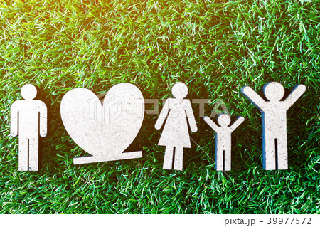 Wooden family on green grass 39977572