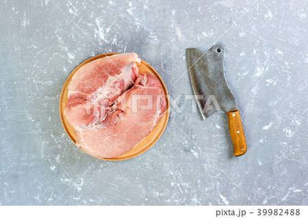 Raw cut of pork shoulder on board with knife 39982488