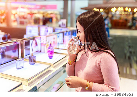 Asian woman testing and choose to buy perfume Asian woman testing and choose to buy perfume 39984953