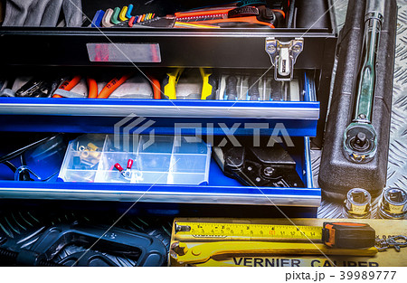 Tools in box on checkered plate background 39989777