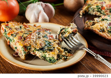 Portion of frittata made of eggs and mushrooms Portion of frittata made of eggs and mushrooms 39990023