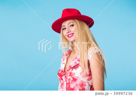 Portrait of happy cheerful smiling young beautiful blond woman on blue background Portrait of happy cheerful smiling young beautiful blond woman on blue background 39997236