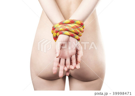 Hands bound by rope behind 39998471