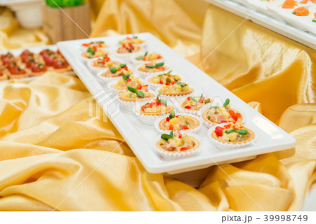 Close up plate with tartalets on catering table  39998749