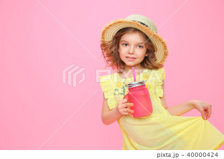 Stylish little girl with drink on pink 40000424