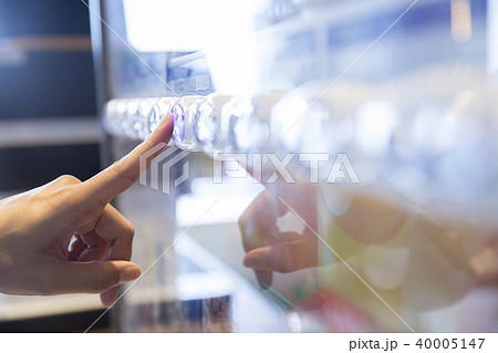 自動販売機のボタンを押す女性手元 40005147