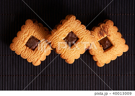 Stacked chocolate chip cookies on black table Stacked chocolate chip cookies on black table 40013009