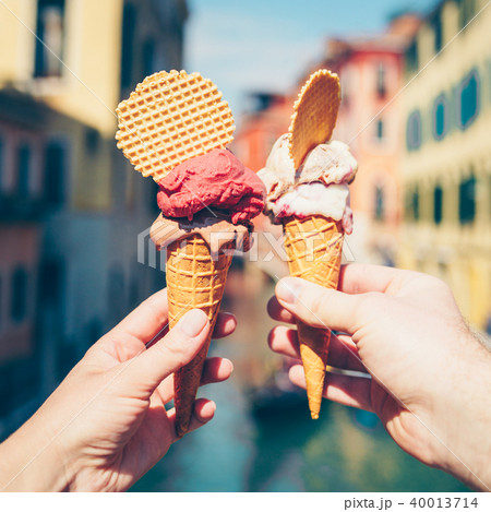 Hands holding ice cream in waffle cone. Hands holding ice cream in waffle cone. 40013714