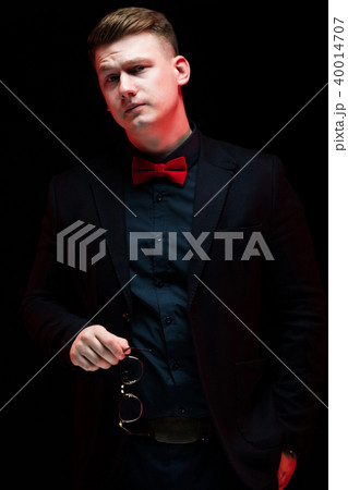 Portrait of confident handsome elegant responsible businessman with glasses in his hand thinking on Portrait of confident handsome elegant responsible businessman with glasses in his hand thinking on 40014707