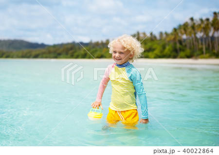 Child on tropical beach. Sea vacation with kids. 40022864