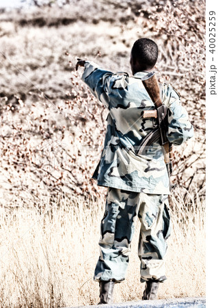 a black soldier and his gun looking the  boarder 40025259
