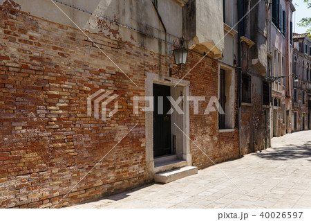 Typical view of a narrow Venice street in summer sunny day. Red brick building Typical view of a narrow Venice street in summer sunny day. Red brick building 40026597