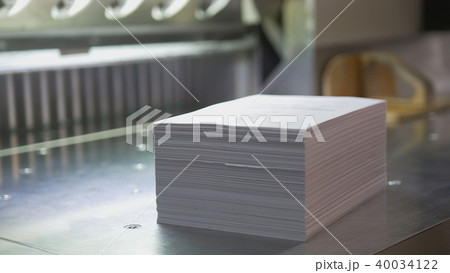 Typography - stack of paper near cutting machine 40034122