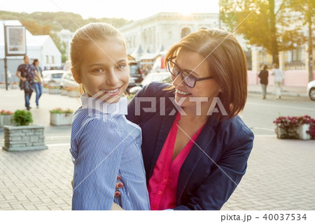 mom and her daughter are hugging and smiling. mom and her daughter are hugging and smiling. 40037534