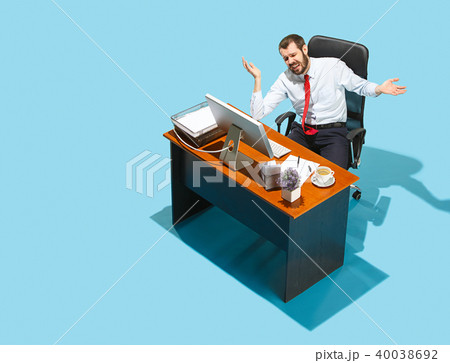 Shot from above of a stylish business man working on a laptop. Shot from above of a stylish business man working on a laptop. 40038692