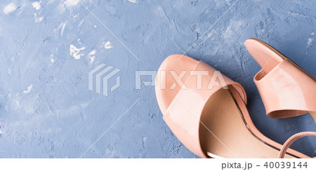 Pair of woman pink sandals on blue background 40039144