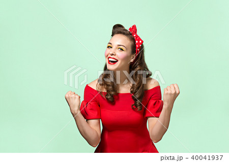 Beautiful young woman with pinup make-up and hairstyle. Studio shot on white background 40041937