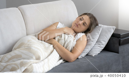 Portrait of brunette young woman feeling sick 40050410