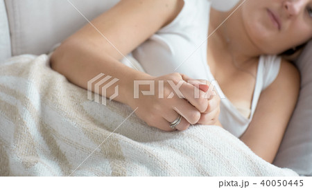 Closeup image of female hands lying on sofa Closeup image of female hands lying on sofa 40050445
