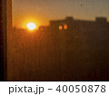 View of red sunset behind very dusty glass 40050878