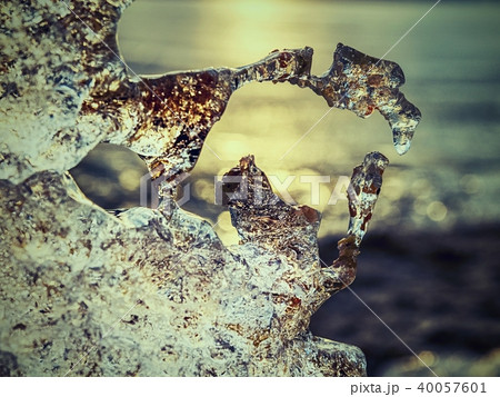 Dark water of the lake comes and melts white ice Dark water of the lake comes and melts white ice 40057601