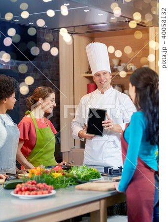 happy women with chef and tablet pc in kitchen happy women with chef and tablet pc in kitchen 40058132
