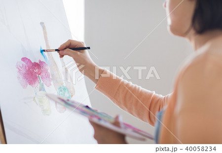 artist with palette and brush painting at studio artist with palette and brush painting at studio 40058234